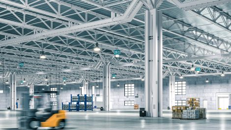 Wide-angle view of a spacious, well-lit warehouse with forklift in motion blur. 3d render